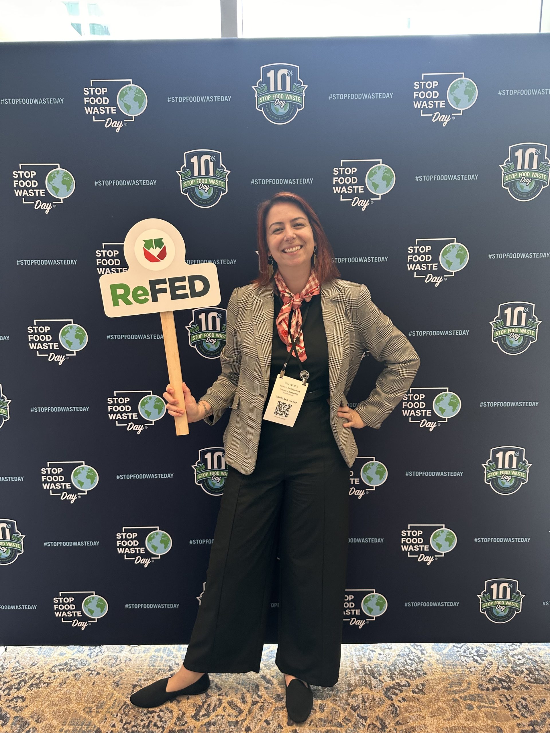 Alex Frantz standing in front of a step and repeat at the 2026 ReFED Food Waste Solutions Summit