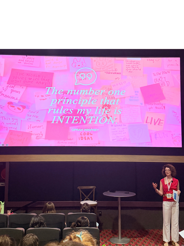 Kate Edwards on stage at FAB 2026 with quote from Oprah on the screen