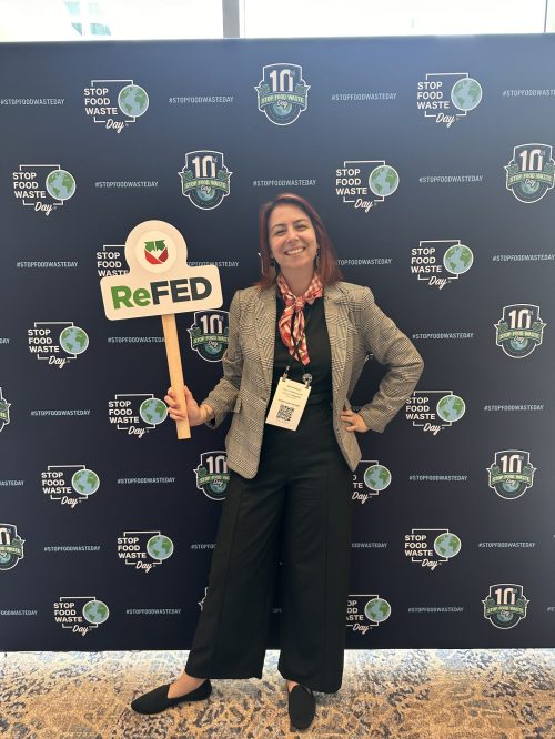 Alex Frantz standing in front of a step and repeat at the 2026 ReFED Food Waste Solutions Summit